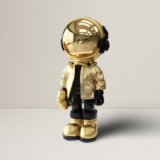 Groot astronautenbeeld in metallic goud op een witte achtergrond

